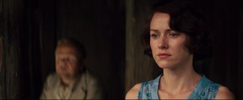 Movie still from “The Painted Veil” (2006), directed by John Curran – A woman in a blue dress is looking at the camera; Close Up shot, Over the shoulder angle
