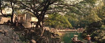 Movie still from “The Painted Veil” (2006), directed by John Curran – A large tree in front of a body of water; Extreme Wide shot, High angle