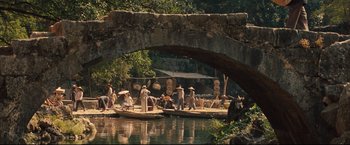 Movie still from “The Painted Veil” (2006), directed by John Curran – A group of people on a boat on a body of water; Extreme Wide shot, High angle