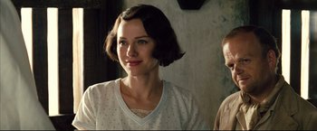 Movie still from “The Painted Veil” (2006), directed by John Curran – A woman with short brown hair wearing a polka dot shirt; Close Up shot, Over the shoulder angle