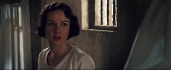 Movie still from “The Painted Veil” (2006), directed by John Curran – A woman with short hair and a white shirt is looking at the camera; Close Up shot, Over the shoulder angle