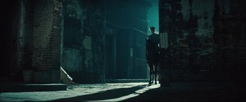 Movie still from “The Painted Veil” (2006), directed by John Curran – Two people are standing in a dark alleyway; Wide shot, Low angle