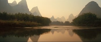 Movie still from “The Painted Veil” (2006), directed by John Curran – A body of water with mountains in the background; Extreme Wide shot, High angle