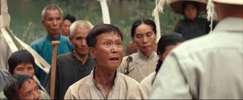 Movie still from “The Painted Veil” (2006), directed by John Curran – A group of people standing in a forest; Close Up shot, Over the shoulder angle