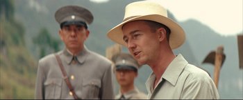 Movie still from “The Painted Veil” (2006), directed by John Curran – A group of men in hats standing next to each other; Close Up shot, Over the shoulder angle