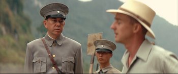 Movie still from “The Painted Veil” (2006), directed by John Curran – A group of men standing next to each other on top of a hill; Close Up shot, Over the shoulder angle