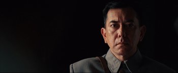 Movie still from “The Painted Veil” (2006), directed by John Curran – A person wearing a suit and tie; Close Up shot, Low angle