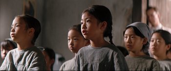 Movie still from “The Painted Veil” (2006), directed by John Curran – Two young girls standing next to each other in a room; Close Up shot, Low angle