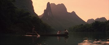 Movie still from “The Painted Veil” (2006), directed by John Curran – Two men are in a boat on a river; Extreme Wide shot, High angle