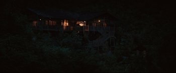 Movie still from “The Painted Veil” (2006), directed by John Curran – A house that has some stairs in the middle of the night; Extreme Wide shot, High angle