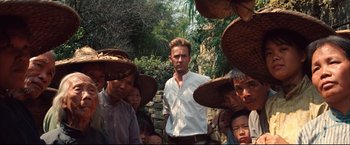 Movie still from “The Painted Veil” (2006), directed by John Curran – A group of people wearing hats and standing next to each other; Medium shot, Over the shoulder angle