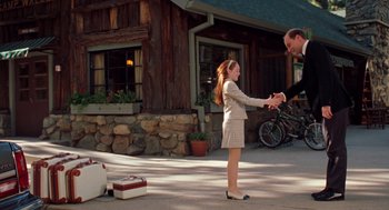 Movie still from “The Parent Trap” (1998), directed by Nancy Meyers – A little girl shaking hands with an older man; Medium shot, Over the shoulder angle