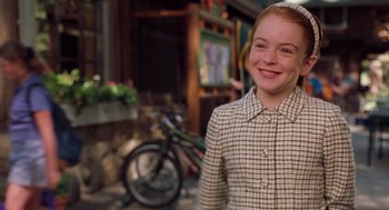 Movie still from “The Parent Trap” (1998), directed by Nancy Meyers – A young girl in a plaid jacket standing in front of a bicycle; Medium shot, High angle