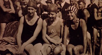 Movie still from “The Parent Trap” (1998), directed by Nancy Meyers – A group of young women sitting next to each other wearing bathing suits; Medium shot, High angle