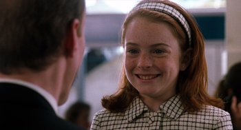 Movie still from “The Parent Trap” (1998), directed by Nancy Meyers – A young girl smiles at a man in a suit; Close Up shot, High angle
