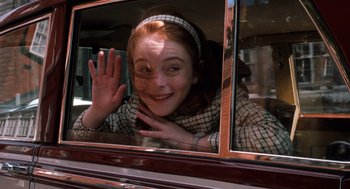 Movie still from “The Parent Trap” (1998), directed by Nancy Meyers – A woman waving from the back seat of a car; Medium shot, High angle