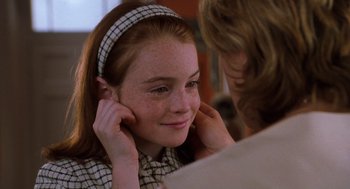 Movie still from “The Parent Trap” (1998), directed by Nancy Meyers – A young girl is smiling with her hands on her face; Close Up shot, Over the shoulder angle