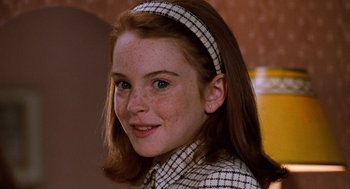 Movie still from “The Parent Trap” (1998), directed by Nancy Meyers – A young girl with red hair wearing a checkered jacket and a headband; Close Up shot, High angle