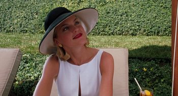 Movie still from “The Parent Trap” (1998), directed by Nancy Meyers – A woman wearing a hat sitting on a chair; Close Up shot, Low angle