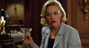 Movie still from “The Parent Trap” (1998), directed by Nancy Meyers – A woman holding a martini glass while wearing red lipstick; Close Up shot, Over the shoulder angle