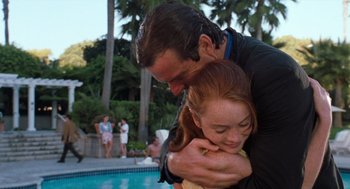 Movie still from “The Parent Trap” (1998), directed by Nancy Meyers – A man and a woman hugging next to a swimming pool; Medium shot, Low angle