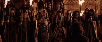 Movie still from “The Passion of the Christ” (2004), directed by Mel Gibson – A group of men dressed in ancient clothing and headdresses; Wide shot, High angle