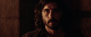 Movie still from “The Passion of the Christ” (2004), directed by Mel Gibson – A person with long hair and a beard; Close Up shot, Low angle