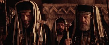 Movie still from “The Passion of the Christ” (2004), directed by Mel Gibson – A group of men standing next to each other; Close Up shot, Low angle