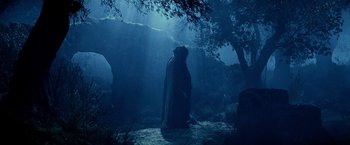 Movie still from “The Passion of the Christ” (2004), directed by Mel Gibson – A man in a black robe standing in the dark; Wide shot, Low angle