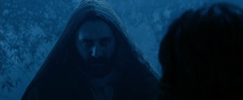 Movie still from “The Passion of the Christ” (2004), directed by Mel Gibson – A man with a beard is wearing a hooded cloak; Close Up shot, Low angle