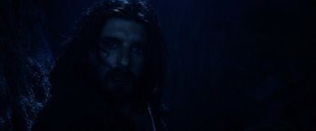 Movie still from “The Passion of the Christ” (2004), directed by Mel Gibson – A man with long black hair is in the dark; Close Up shot, Low angle