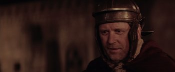 Movie still from “The Passion of the Christ” (2004), directed by Mel Gibson – A person wearing a helmet; Close Up shot, Over the shoulder angle