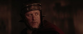 Movie still from “The Passion of the Christ” (2004), directed by Mel Gibson – A person wearing a helmet; Close Up shot, Over the shoulder angle