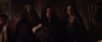 Movie still from “The Passion of the Christ” (2004), directed by Mel Gibson – A group of people standing next to each other in the dark; Medium shot, Over the shoulder angle