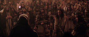 Movie still from “The Passion of the Christ” (2004), directed by Mel Gibson – A group of men in medieval garb in front of a crowd; Wide shot, High angle
