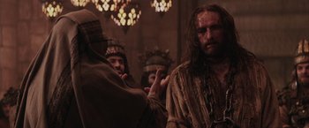 Movie still from “The Passion of the Christ” (2004), directed by Mel Gibson – A group of men standing next to each other in a room; Medium shot, Over the shoulder angle