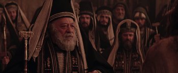 Movie still from “The Passion of the Christ” (2004), directed by Mel Gibson – A group of men dressed in religious clothing; Medium shot, Over the shoulder angle