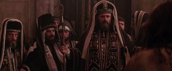 Movie still from “The Passion of the Christ” (2004), directed by Mel Gibson – A group of men standing next to each other; Medium shot, Low angle