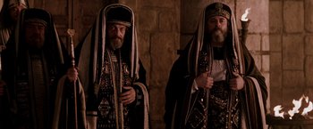 Movie still from “The Passion of the Christ” (2004), directed by Mel Gibson – A couple of men standing next to each other; Medium shot, Low angle