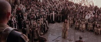 Movie still from “The Passion of the Christ” (2004), directed by Mel Gibson – A group of people dressed up in robes and hoods; Extreme Wide shot, High angle