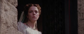 Movie still from “The Passion of the Christ” (2004), directed by Mel Gibson – A woman in a white dress standing in front of a curtain; Close Up shot, Low angle