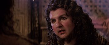 Movie still from “The Passion of the Christ” (2004), directed by Mel Gibson – A person with long curly hair; Close Up shot, Over the shoulder angle