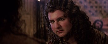 Movie still from “The Passion of the Christ” (2004), directed by Mel Gibson – A person with long curly hair; Close Up shot, Over the shoulder angle