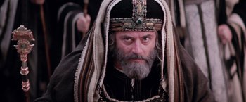 Movie still from “The Passion of the Christ” (2004), directed by Mel Gibson – A man with a beard wearing a turban and a beard; Close Up shot, Low angle