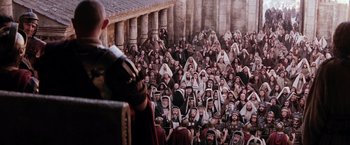 Movie still from “The Passion of the Christ” (2004), directed by Mel Gibson – A large group of men in robes and headpieces; Extreme Wide shot, High angle