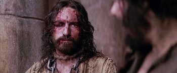 Movie still from “The Passion of the Christ” (2004), directed by Mel Gibson – A person wearing a chain; Close Up shot, Low angle