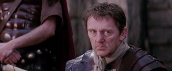 Movie still from “The Passion of the Christ” (2004), directed by Mel Gibson – A person wearing a suit and tie; Close Up shot, Low angle