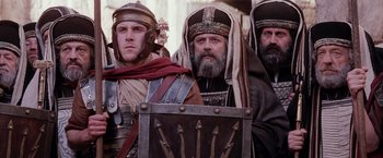 Movie still from “The Passion of the Christ” (2004), directed by Mel Gibson – A group of men dressed in ancient roman clothing; Medium shot, Low angle