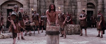 Movie still from “The Passion of the Christ” (2004), directed by Mel Gibson – A group of men standing next to each other; Medium shot, Low angle