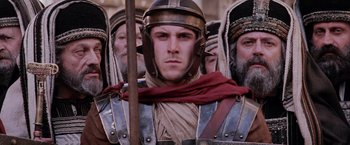 Movie still from “The Passion of the Christ” (2004), directed by Mel Gibson – A group of men in roman garb standing next to each other; Close Up shot, Low angle